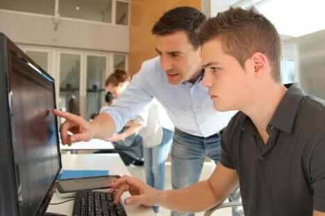 Young boy learning to use online accounting software