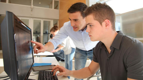 Young boy learning to use online accounting software